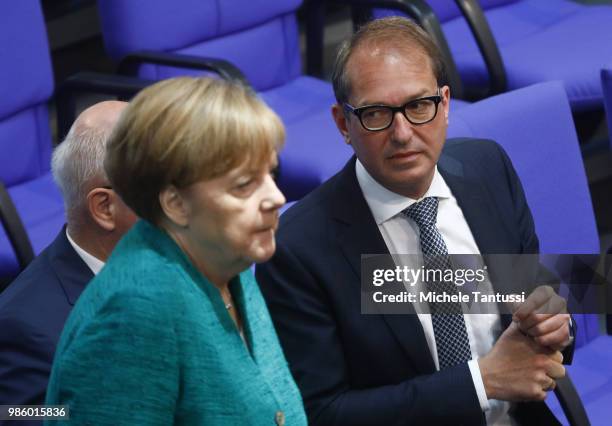 Bavarian Christian Democrats Bundestag fraction leader Alexander Dobrindt looks at German Chancellor Angela Merkel after she gave a government...