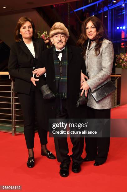 Film producer Artur Brauner, his daughter Alice Brauner and company 'Bettina' attend the opening night of the film 'Isle of Dogs' during the...