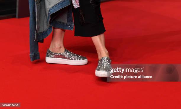February 2018, Berlin: Berlinale, Opening, 'Isle of Dogs': Actress Meret Becker wears silver sequined shoes. Photo: Jens Kalaene/dpa