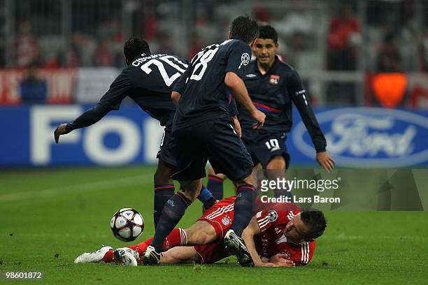 Ivica Olic of Bayern is challenged by Jeremy Toulalan, Aly Cissokho and Ederson of Lyon during the UEFA Champions League semi final first leg match...