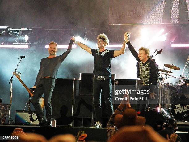 Sting, Stewart Copeland and Andy Summers of The Police take a final bow and wave the crowd farewell after performing on stage on Day 2 of 'Hard Rock...