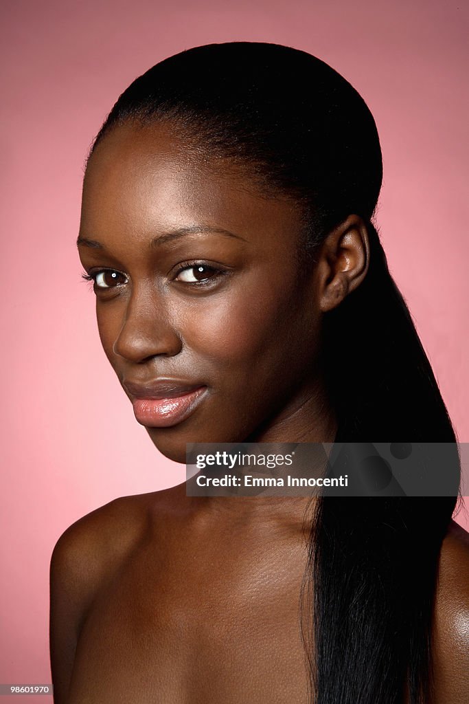 Young woman with bare shoulders and ponytail