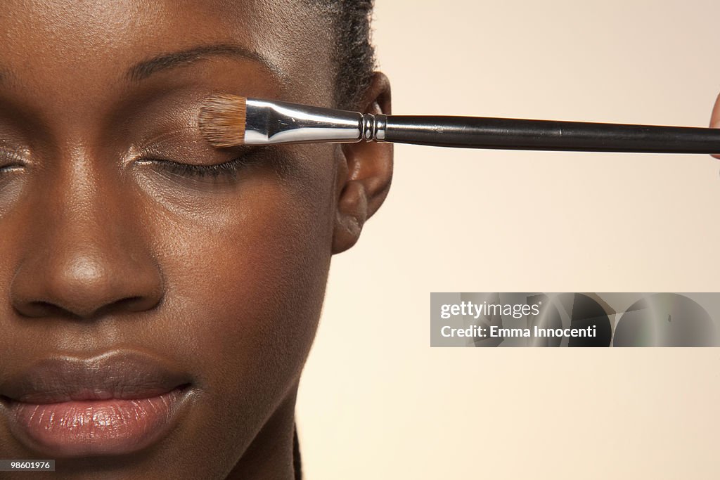 Woman with eye make up brush on eye