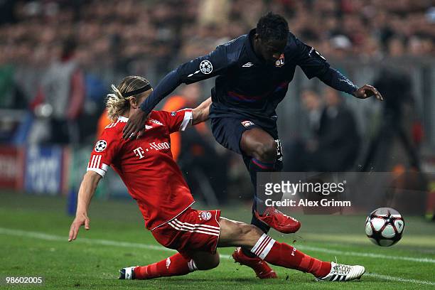 Anatoli Timoschtschuk of Bayern challenges Aly Cissokho of Lyon during the UEFA Champions League semi final first leg match between FC Bayern...