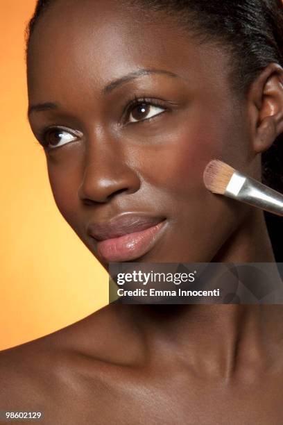 young woman applying make up blush on chick - woman applying blush stock pictures, royalty-free photos & images