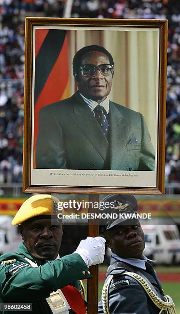 Zimbabwean solders march with President Robert Mugabe's portrait at Harare National Stadium during celebrations of Zimbabwe's 30 years of...