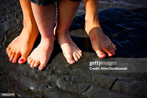 mother and son feet in the mud - white rock bc stock pictures, royalty-free photos & images