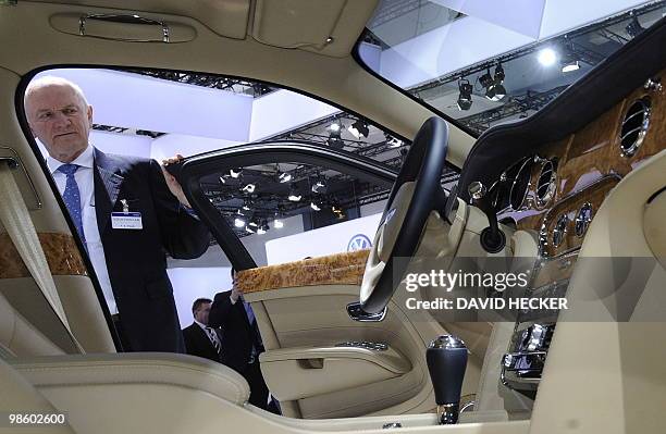 Ferdinand Piech, supervisory board chairman of German car maker Volkswagen , opens the door of a Bentley car during VW's annual general meeting on...