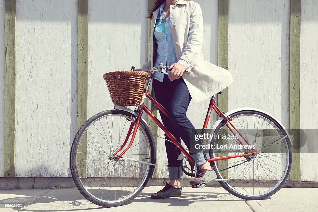 Classic cruiser bicycle with basket and woman