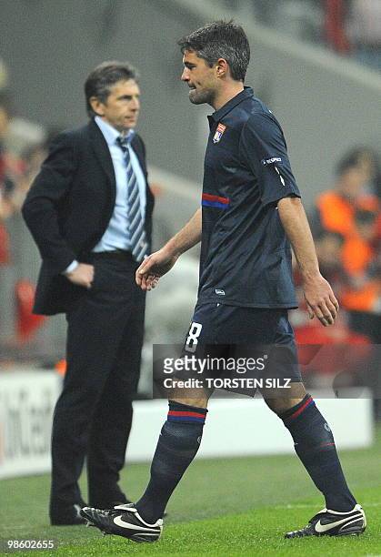 Olympique Lyonnais' French midfielder Jérémy Toulalan walks off past Olympique Lyonnais' coach Claude Puel after receiving the red card during the...