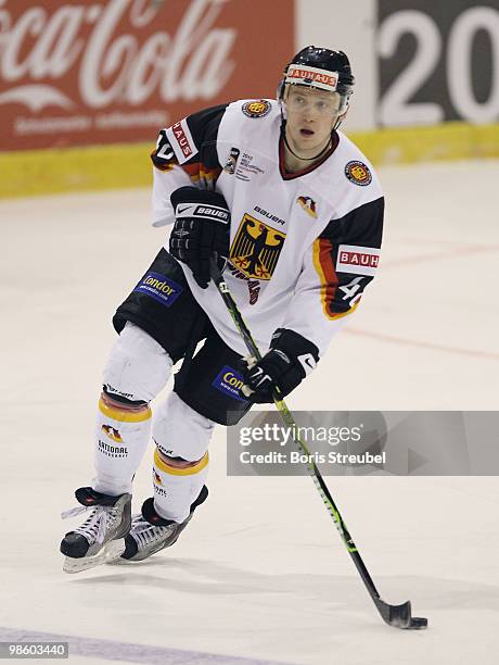 Frank Hoerdler of Germany controls the puck during the pre IIHF World Championship match between Germany and Norway at the Sahnpark on April 16, 2010...