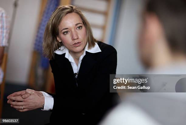 German Family Minister Kristina Schroeder chats with male high school students considering a future in child care during a visit to the Spreekita...