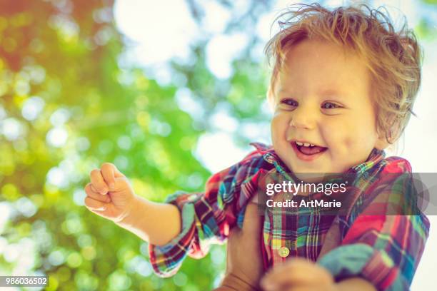 cute child having fun in summer park - artmarie stock pictures, royalty-free photos & images