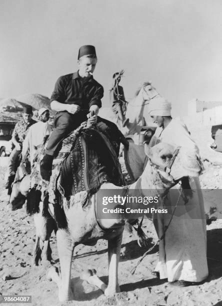 Tottenham Hotspur winger Terry Dyson riding a camel during a sightseeing visit to the pyramids at El Giza, Egypt, 15th November 1962. Spurs were in...