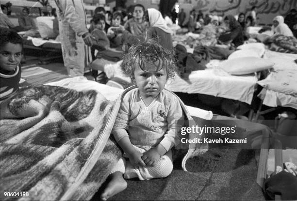 Young Iraqi Kurdish child sits on a hospital bed with chemical gas injuries in Oshnavieh, Iran after having fled a chemical gas attack in northern...