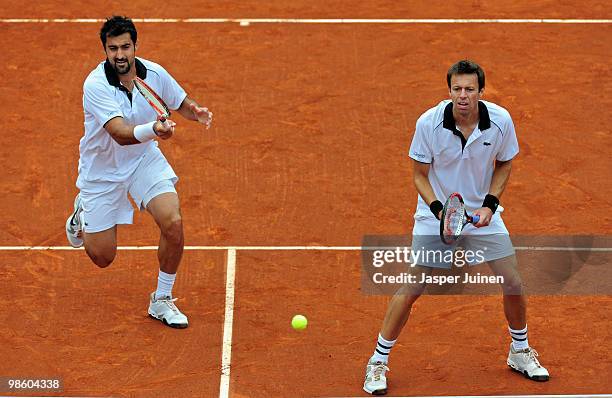 Nenad Zimonjic of Serbia plays a forehand flanked by his doubles partner Daniel Nestor of Canada to Jordan Kerr of Australia and Robert Lindstedt of...