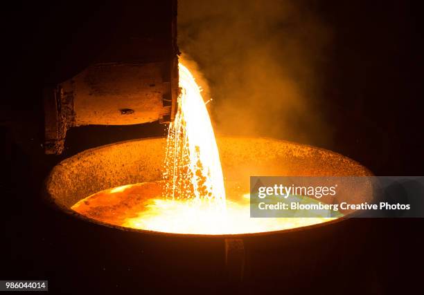 a ladle pours finished molten steel at a plant - molten stock pictures, royalty-free photos & images