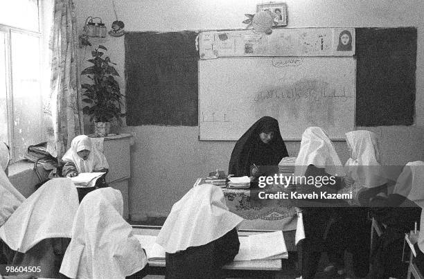 School girls in Islamic with their female teacher covered in black chador in a primary school classroom in Tehran , 1st October 1997. It is...