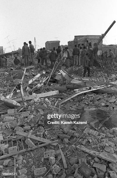 People search in the rubble after houses in a residential area were destructed by a Mirage plane used by Iraqi air force moments after the air...