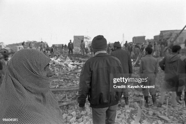 Terrified woman looks at destruction made by a Mirage plane used by Iraqi air force moments after the bombing in Abadan, south Iran.