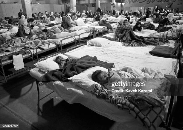 Iraqi Kurds sit in a makeshift hospital in Oshnavieh, Iran after having fled a chemical gas attack in northern Iraq, 5th August 1988. Towards the end...