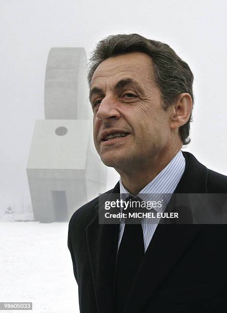 French president Nicolas Sarkozy talks to the medias in the snow as he visits Les Gliers Memorial during a ceremony to pay tribute to World War II...