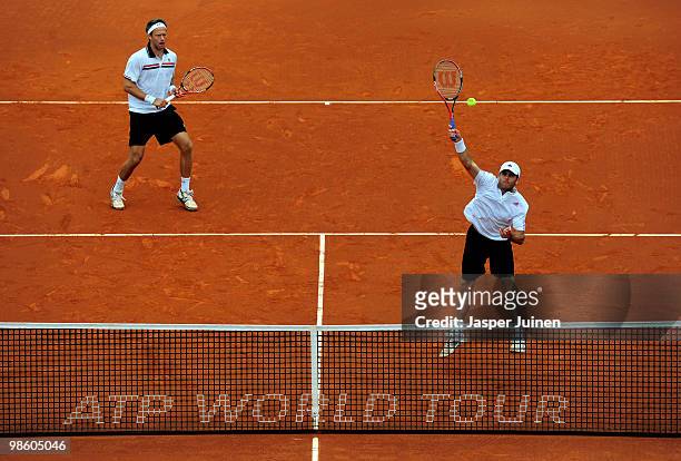 Jordan Kerr of Australia jumps to smash a forehand flanked by his doubles partner Robert Lindstedt of Sweden to Nenad Zimonjic of Serbia and Daniel...