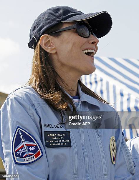 France's first lady Carla Bruni-Sarkozy patron of the French aerobatic squadron "Patrouille de France" reacts as she attends an exhibition in...