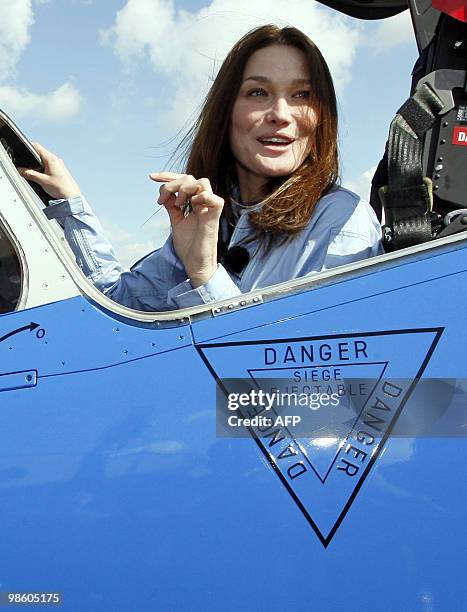 France's first lady Carla Bruni-Sarkozy patron of the French aerobatic squadron "Patrouille de France" sits in the cockpit of an Alpha jet after an...