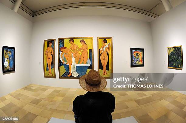 Man looks at the triptych "Women Bathing" by German artist Ernst Ludwig Kirchner during a press preview at the Staedel Museum in Frankfurt/M.,...