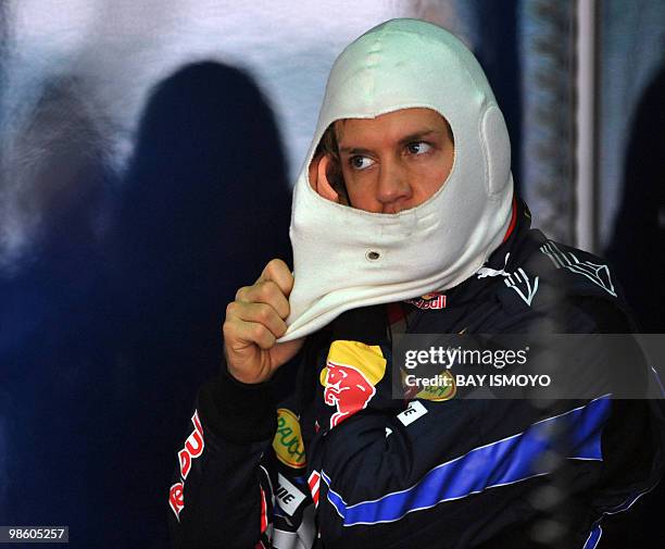 Red Bull-Renault driver Sebastian Vettel of Germany prepares for the first practice session for Formula One's Malaysian Grand Prix in Sepang on April...