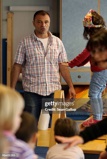 Male preschool teacher Uwe Draeger oversees children playing prior to a visit by German Family Minister Kristina Schroeder to the Spreekita child day...