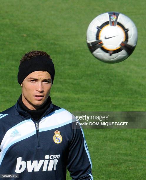 Real Madrid football club's Portuguese forward Cristiano Ronaldo eyes the ball during a training session in Madrid on April 2, 2010. Barcelona and...