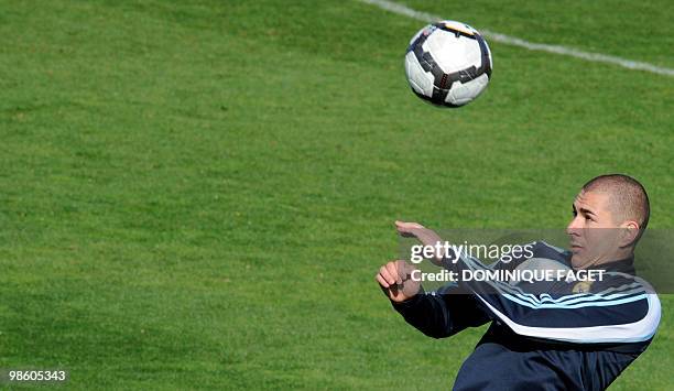 Real Madrid football club's French forward Karim Benzema heads the ball during a training session in Madrid on April 02, 2010. Barcelona and Real...