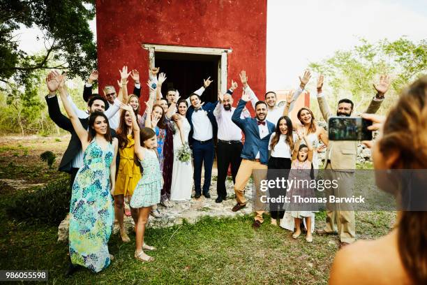 woman taking photo with smartphone of wedding party celebration after ceremony - wedding after party stock pictures, royalty-free photos & images