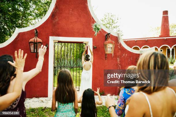 bride throwing bouquet during outdoor wedding reception - catching bouquet stock pictures, royalty-free photos & images