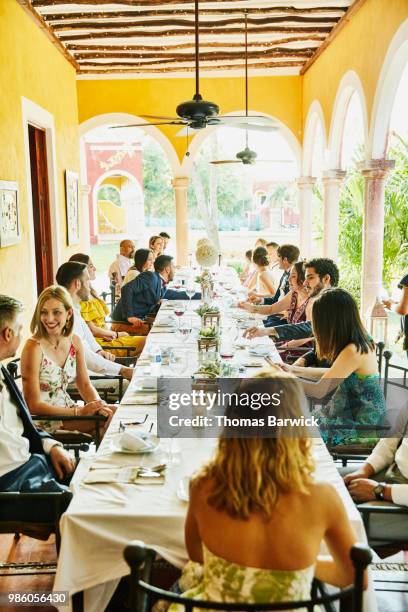 wedding guests seated at table for dinner during outdoor wedding reception - society beauty stock pictures, royalty-free photos & images