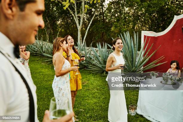 laughing bride at outdoor wedding reception with friends - wedding reception stock-fotos und bilder