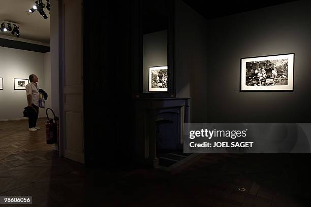 Man looks at photographs from Willy Ronis during the exhibition on the French photographer who would be 100 this year, on April 16, 2010 at the...