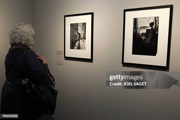 Woman looks at photographs from Willy Ronis during the exhibition on the French photographer who would be 100 this year, on April 16, 2010 at the...