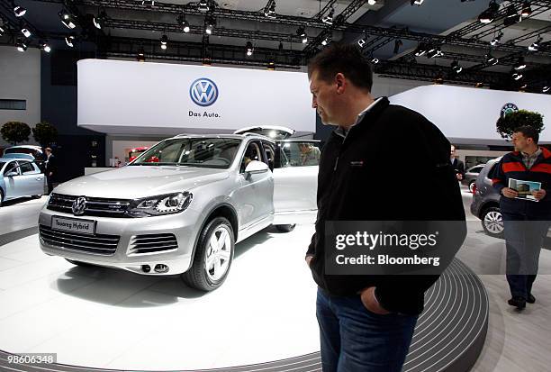 Visitor looks at a Volkswagen AG Touareg automobile at the company's annual shareholders' meeting in Hamburg, Germany, on Thursday, April 22, 2010....
