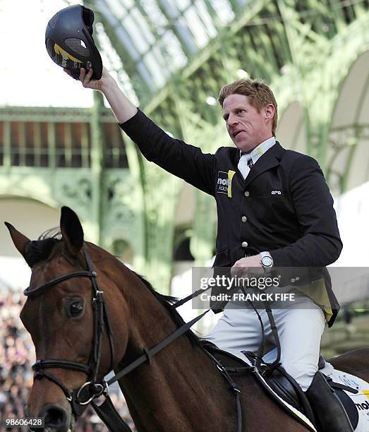 German Marcus Ehning, on Sabrina, celebrates after winning the International Jumping Competition on April 4 at The Grand Palais in Paris. AFP PHOTO /...