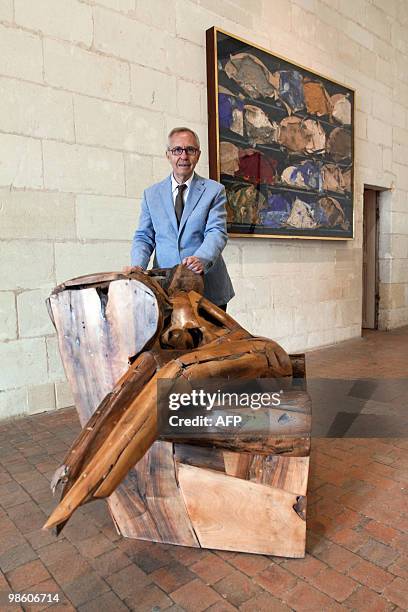 Spanish artist Manolo Valdes poses in front of his sculpture "Mujer sentada" on April 22, 2010 at the Chambord castle on the first day of the...