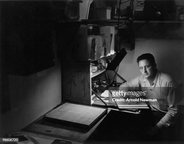 Portrait of American photographer Arnold Newman as he writes at a desk, Miami Beach, Florida, April 2, 1943.