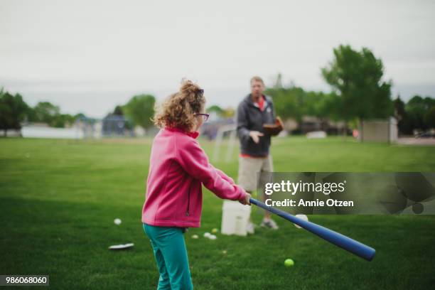 girl hitting baseball - kid baseball pitcher stock pictures, royalty-free photos & images