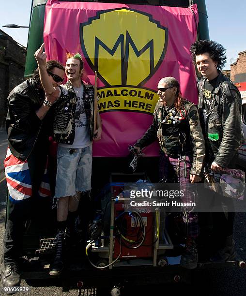 Punks ride the Malcolm McLaren funeral procession bus as it passes through Camden Town on its way to Highgate cemetery, on April 22, 2010 in London,...