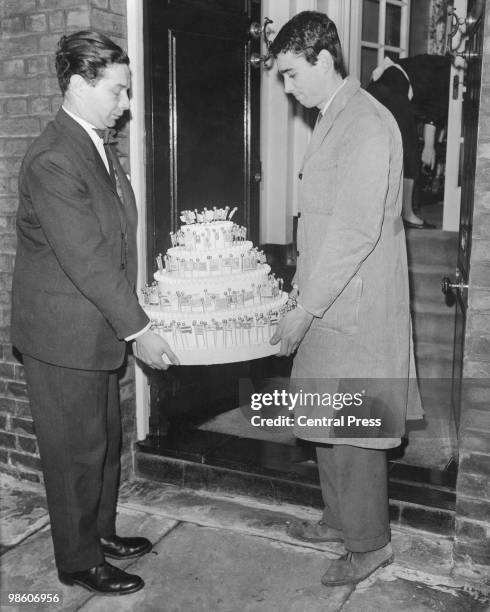 Sir Winston Churchill's 85th birthday cake arrives at his Hyde Park Home, London, 30th November 1959. The 80 lb cake is decorated with flags and...