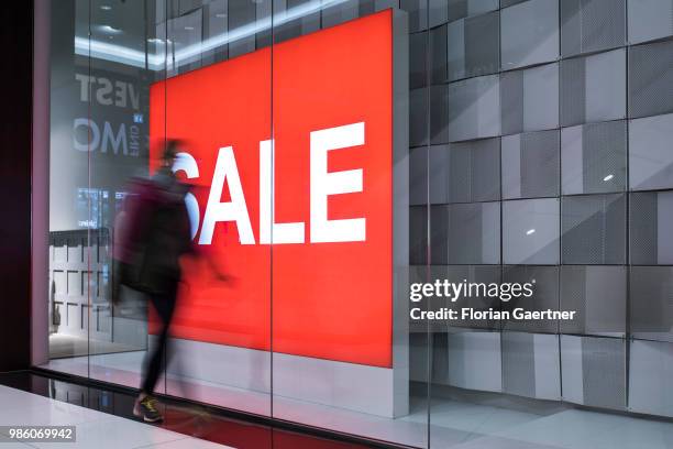 Woman walks along the lettering 'Sale' on June 23, 2018 in Berlin, Germany.