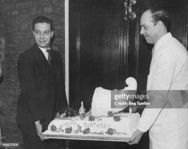 Sir Winston Churchill's 86th birthday cake, decorated with a cornucopia, arrives at his Hyde Park Home, London, 30th November 1960.