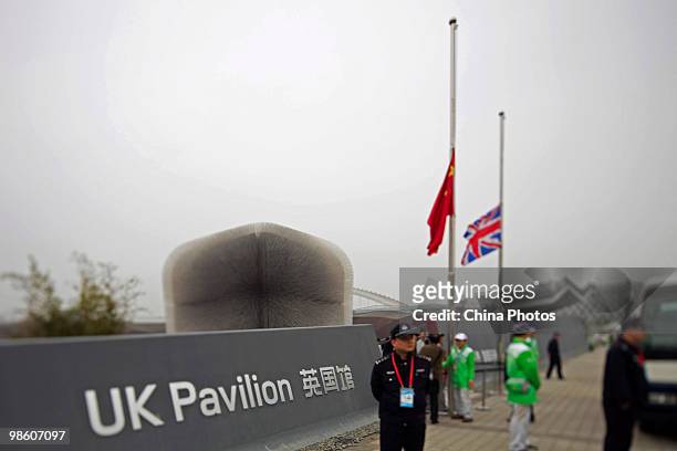 The flag of Chinese national flag and UK national flag fly at half-mast to mourn victims in the Yushu earthquake at the World Expo site on April 21,...
